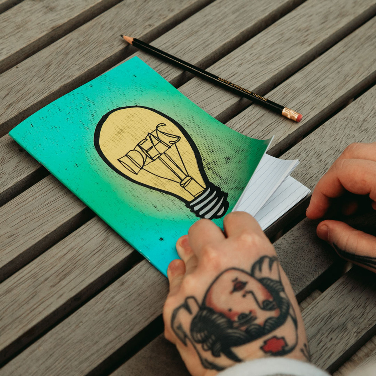 Image of a hand opening a notebook