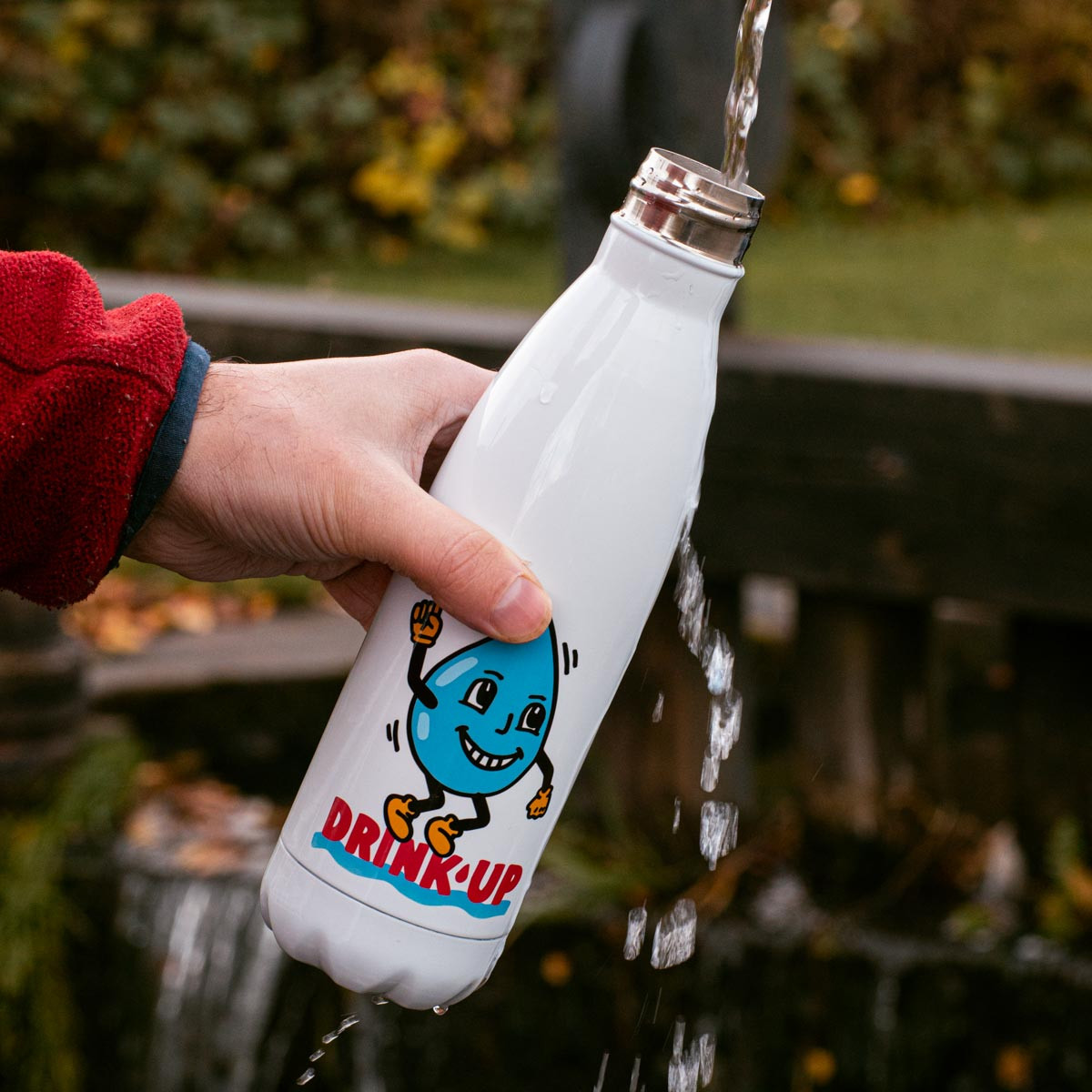 A picture of someone filling up a water bottle